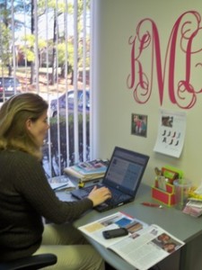 K & K Designs Co-Owner Kristin Melton in front of her sassy wall applique. Yeah, it's that cute.